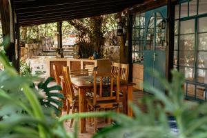 a wooden table and chairs on a patio at חוות טפת בגלבוע-חוויה של טבע בצפון in Nurit
