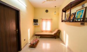 a living room with a couch and a window at Villa 9 degrees north in Sultan Bathery