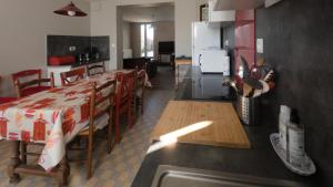 a kitchen and dining room with a table and chairs at Les Gîtes d'Argonne in Rarécourt +26 photos