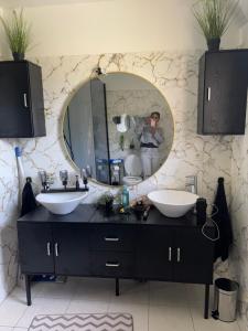 a person taking a picture of a mirror in a bathroom at Chambre Serres Ponçon in Savines +28 photos