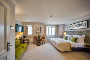 a hotel room with a large bed and a couch at Hotel Aragon in Bruges +92 photos