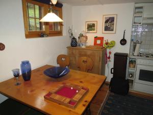 a kitchen with a wooden table and a table and a table at Fewo Steinbachhaus in Praden