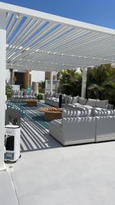 a group of white couches sitting under a canopy at Seashell 2nd row sea Villa in El Alamein