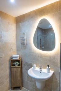 a bathroom with a sink and a mirror at Luss Cottages at Glenview in Luss +60 photos