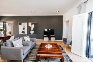 a living room with a couch and a table at Lorelei Guest House in George