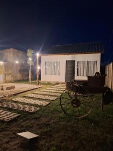 a house with a cart in front of it at night at MiniChino Casa Interna in Pehuajo