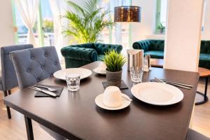 a table with plates and napkins on top of it at The Business Loft in Wolfsburg