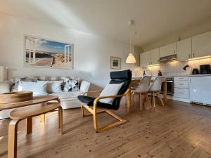 a living room with a couch and a table and chairs at Altes Wasserwerk App 10 in Wustrow