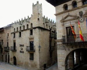 a building with two flags on top of it at Fonda la Plaza in Valderrobres +41 photos