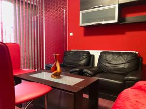 a living room with two leather chairs and a table at Joy City Stay Calea Timisoarei 4 in Timişoara