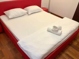 a white bed with a red frame and white pillows at Joy City Stay Calea Timisoarei 4 in Timişoara