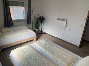 a bedroom with two beds and a window at Easy Stay Valencia in Oberboihingen +6 photos