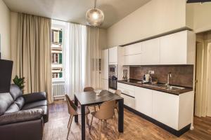 a kitchen and living room with a table and chairs at Le Due Piazze in Genoa