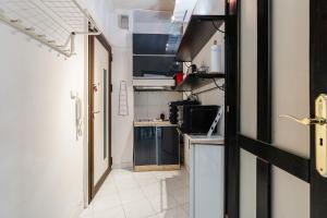 a small kitchen with a stove and a sink at Madach City Studio in Budapest