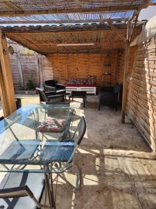 a patio with a ping pong table and chairs at Mareva House - Discreet with parking in Gignac-la-Nerthe