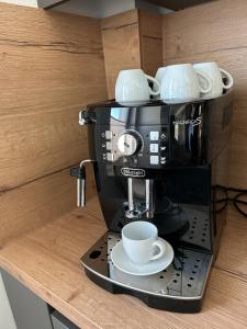 a coffee maker with a cup on a counter at City Apartment in Bremen