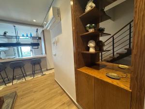 a living room with a staircase and a room with stools at سكاي لاين سويت in Tunis