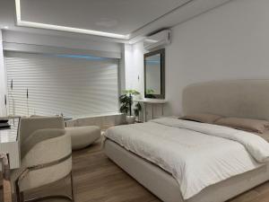 a bedroom with a bed and a desk and a window at سكاي لاين سويت in Tunis +21 photos