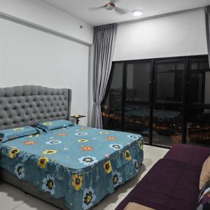 a bedroom with a bed and a large window at Eduscentral Stanford, Setia Alam in Shah Alam