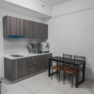 a kitchen with a table and chairs in a room at Eduscentral Stanford, Setia Alam in Shah Alam +4 photos