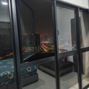 a room with a view of a city at night at Eduscentral Stanford, Setia Alam in Shah Alam