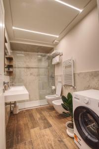 a bathroom with a toilet and a sink and a washing machine at Le Due Piazze in Genoa +84 photos