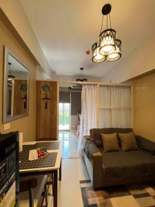 a living room with a couch and a table at KEY REALTY SERVICES Ph in Pajak