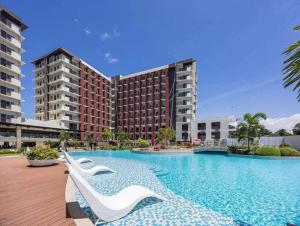 a large swimming pool in front of a building at KEY REALTY SERVICES Ph in Pajak