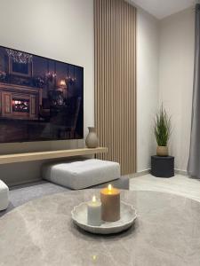 a living room with two candles on a table at Pearl Luxury Suites in Paralia Dionysiou