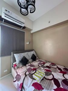 a bedroom with a bed with a colorful comforter at KEY REALTY SERVICES Ph in Pajak +9 photos