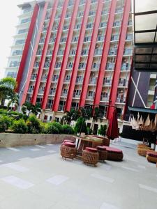 a large red building with tables and chairs in front of it at KEY REALTY SERVICES Ph in Pajak