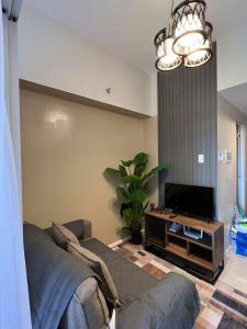 a living room with a couch and a flat screen tv at KEY REALTY SERVICES Ph in Pajak
