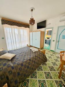 a bedroom with a bed and a large window at Riviera B&B Rooms & Apartment SEA-VIEW in Maiori