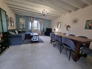 a living room with a couch and a table and chairs at Au Mont Chez Nous # Jacuzzi & Sauna # in Pontorson +45 photos