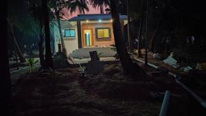 a small house in the woods at night at Rmeshwar homestay in Malvan