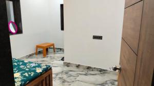 a door leading into a room with a marble floor at Rmeshwar homestay in Malvan