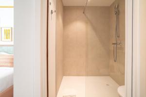 a bathroom with a shower with a glass door at Appartements Soléo Prado in Marseille