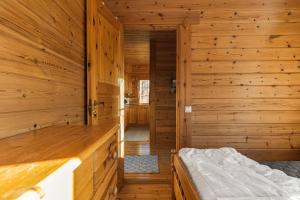 a log cabin with a bed in a room at Ösjan 12 - Bruksvallarna in Bruksvallarna +19 photos