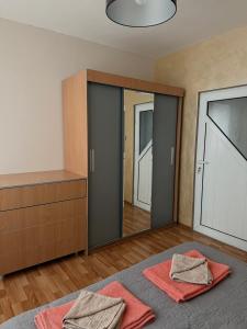 a bedroom with two red towels on a bed at Apartment Rozen in Varna City