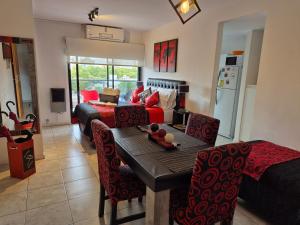 a living room with a table and a couch at Confort Platense Centro Zona Catedral in La Plata