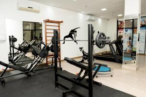 a gym with tread machines and a dog on the wall at Imperial Hotel in Imperatriz