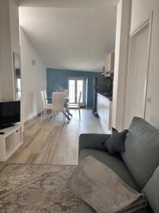 a living room with a couch and a dining room at Appartamenti Lilla in Tremosine Sul Garda