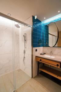 a bathroom with a shower and a sink and a mirror at Alt Life Stays - Manyata Tech Park in Bangalore +55 photos