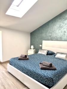 a bedroom with a large bed with two towels on it at Appartamenti Lilla in Tremosine Sul Garda