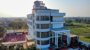 a building with a tower on top of it at Hotel JMS Grand in Jaunpur