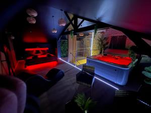 a room with a pool table and a red tub at AMORE suite de luxe & spa in Laplume +7 photos