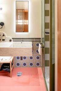 a bathroom with a sink and a mirror at Artcore Hotel Porto in Porto +30 photos