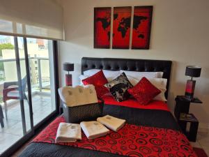 a bedroom with a red bed with red pillows at Confort Platense Centro Zona Catedral in La Plata