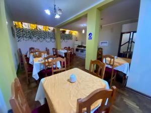 a restaurant with tables and chairs in a room at Nayras Puno Hotel in Puno +86 photos