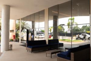 a lobby with couches and chairs in a building at Imperial Hotel in Imperatriz
